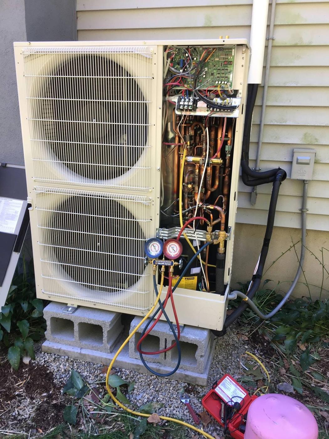 Wayne's HVAC servicing a heat pump with refrigerant gauges connected