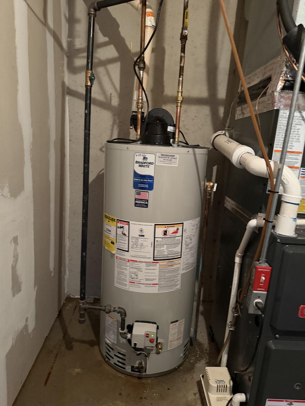Gas water heater installed next to a furnace by Wayne's HVAC
